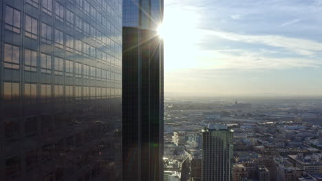 ascending shot alongside skyscrapers reflecting the sun in downtown georgia