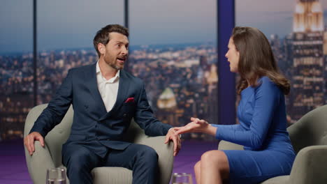 live show expert talking to smiling woman host sitting media studio together.