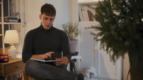 Man using calculator while calculating budget at home