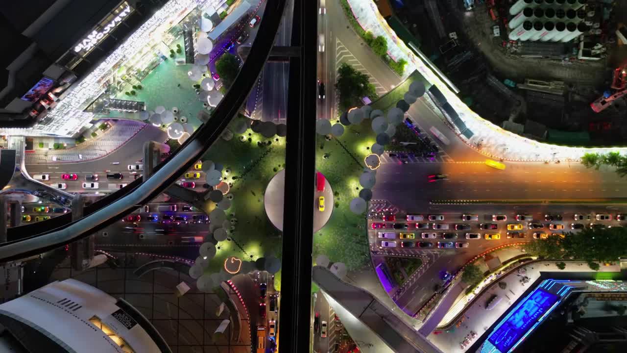 Aerial Time Lapse of Bangkok's Thailand Business Center at Night Traffic Lights and Illuminated Motion, Southeast Asian commercial district with Neon advertisements