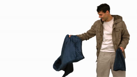 man rolling out his sleeping bag on white screen