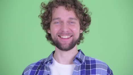 young handsome bearded hipster man with curly hair