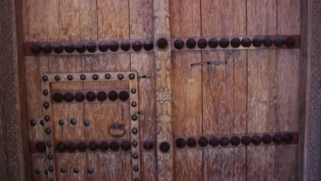 jabreen castle wooden door with studs, oman, static medium shot
