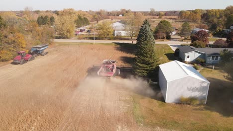 Combine-As-It-Harvests-Soy-Beans-On-Agricultural-Farm-Near-Village-In-Monroe-County,-Michigan,-USA