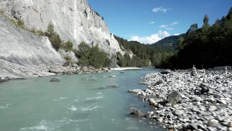 aerial flying along vorderrhein river through scenic ruinaulta canyon