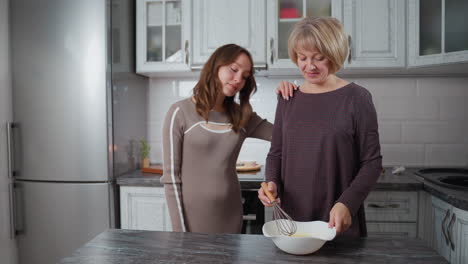 exhausted lady wipes forehead while stirring mixture in white bowl as daughter approaches, showing concern, warm kitchen setting with soft lighting and cozy atmosphere