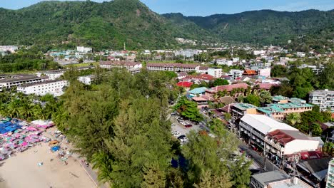 aerial footage showcasing kamala beach and surrounding landscape in phuket, thailand, highlighting vibrant colors and bustling beach activity