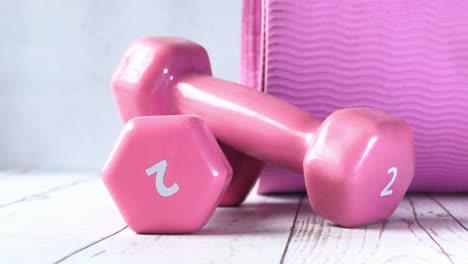 pink dumbbells and exercise mat