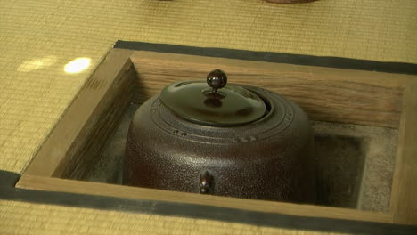 Steam-rises-from-hot-water-kettle-in-Japanese-tea-house