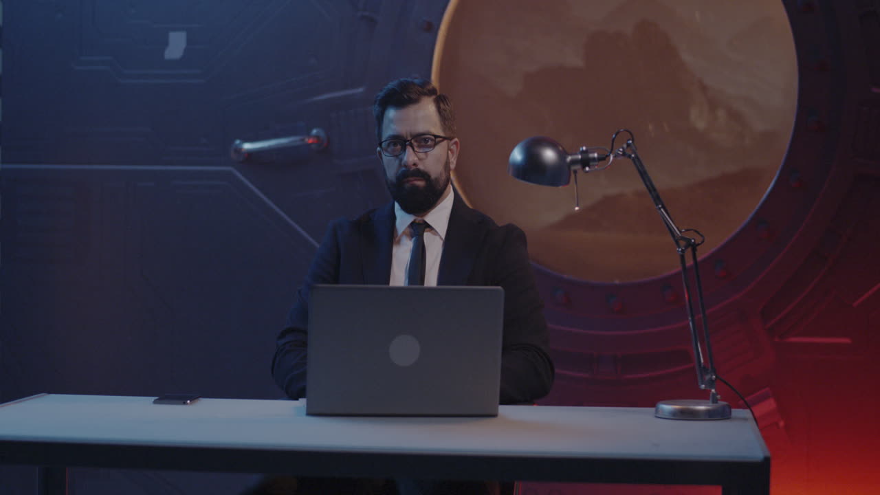 Businessman Working on Laptop in Futuristic Office