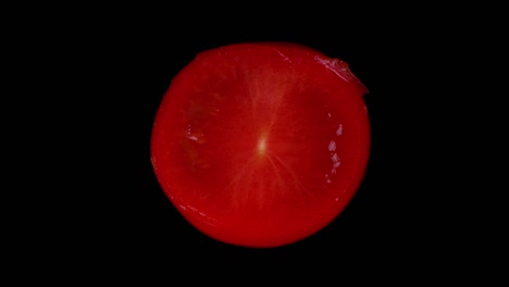 slicing through a juicy red tomato to reveal it's juicy insides. filmed in stop motion