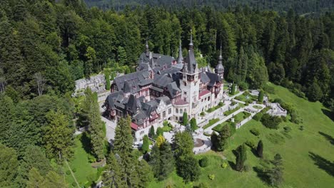 aerial-drone circling shot around peles castle in romania in nature