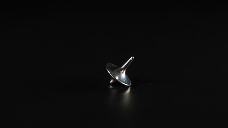 Hand spinning a top on a surface