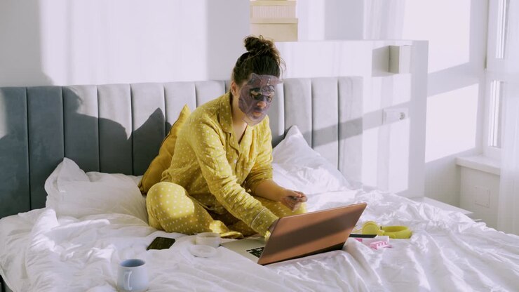 Woman in pajama and funny fascial mask in bed