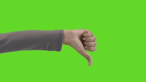 Studio-Close-Up-Shot-Of-Woman-Giving-Thumbs-Down-Sign-Against-Green-Screen-1