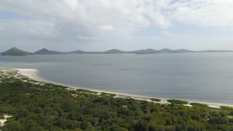 panoramic view of empty beach, mount yacaaba, karuah river, and tomaree mountain in summer - jimmys beach and waynderrabah beach in hawks nest, australia