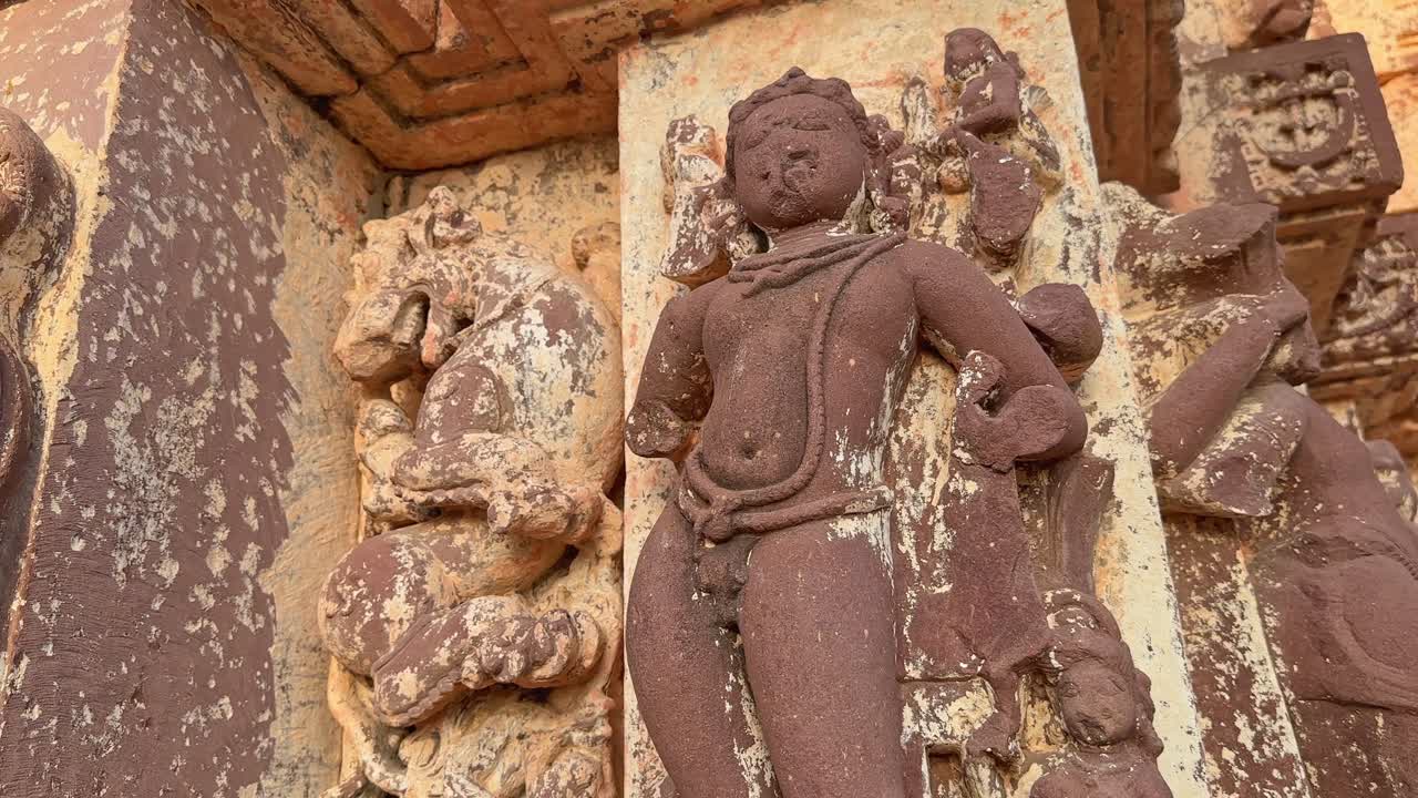Vandalized stone statue of a god on the hindu temple in india