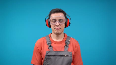 a man wearing safety gear is laughing heartily.