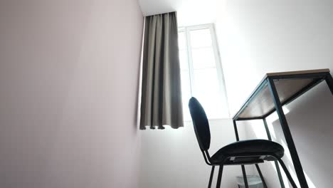 daytime flight towards sunlit room window with table, chair and tranquility