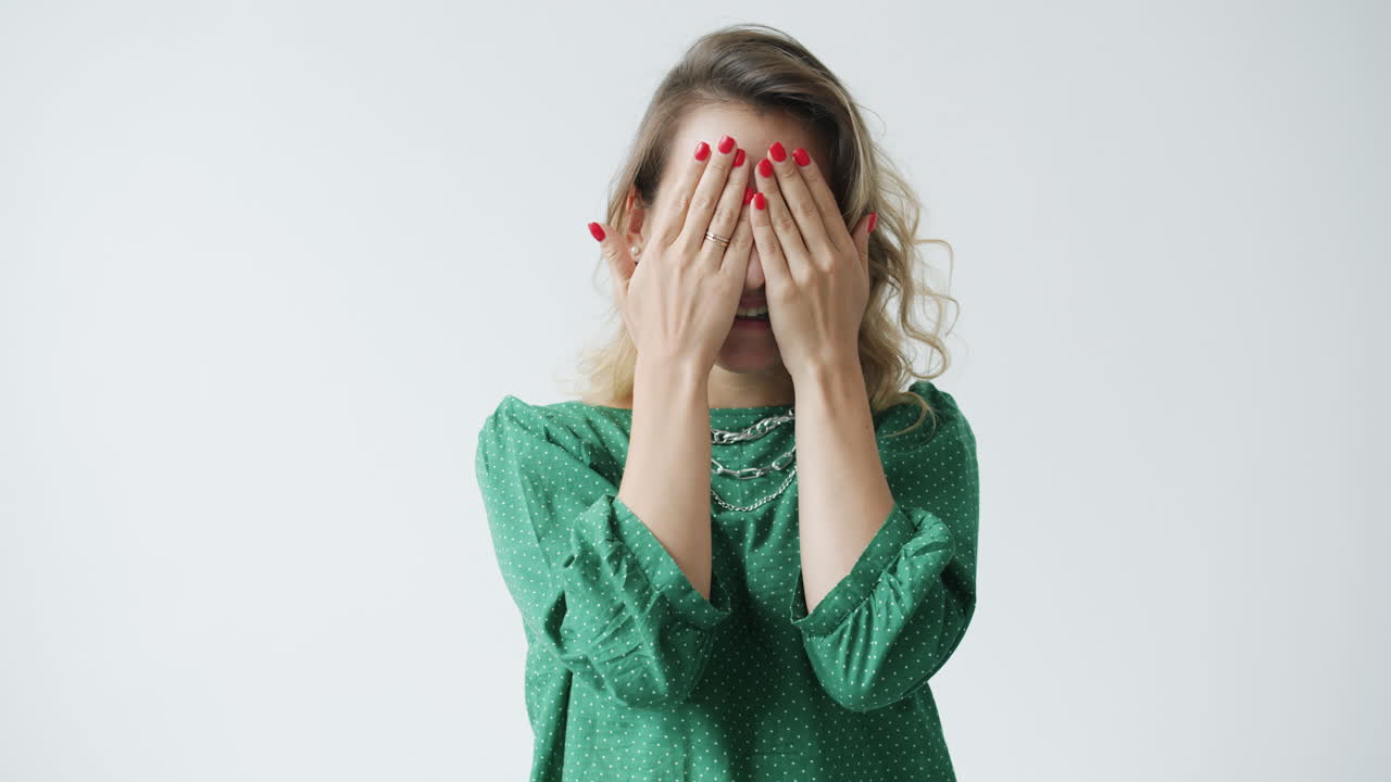 Smiling woman hiding her face