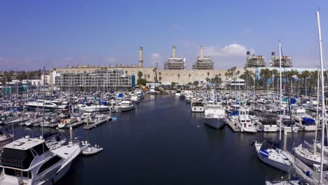 Low-close-up-aerial-shot-of-yachts-and-boats-docked-at-King-Harbor-Marina-in-Redondo-Beach,-California