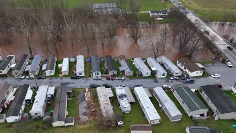 trailer park next to a flooded river