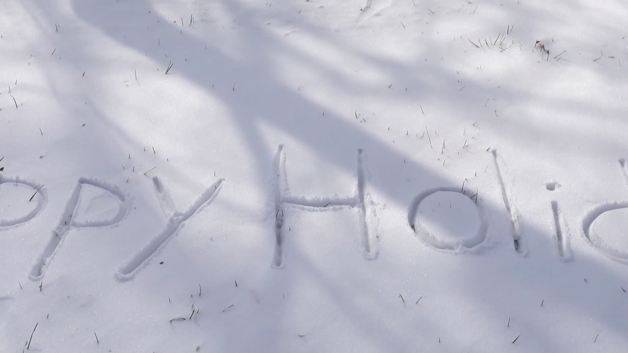 Inscription of happy holidays on snow. Shooting in the winter