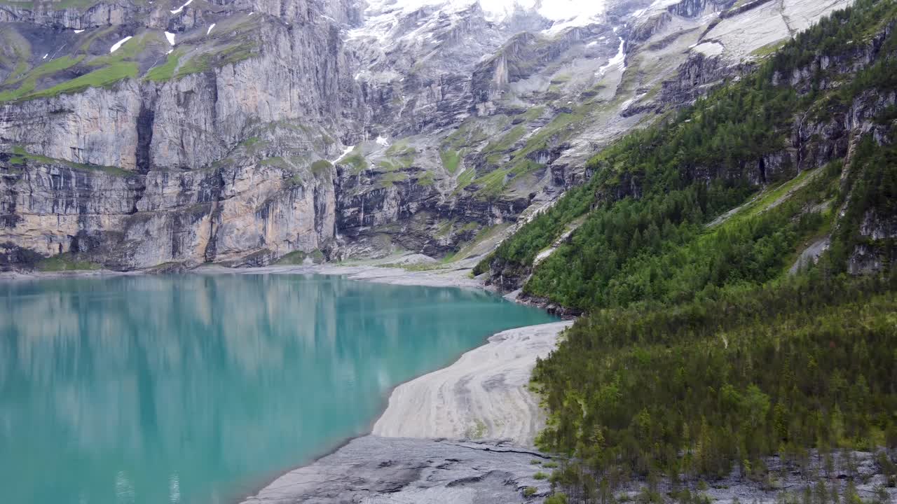 Turquoise azure glacial alpine lake Oeschinen surrounded by swiss Bl&uuml;emlisalp mountains in kandersteg, Switzerland