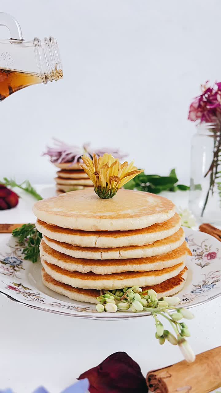 Delicious Stacked Pancakes with Maple Syrup and Flowers
