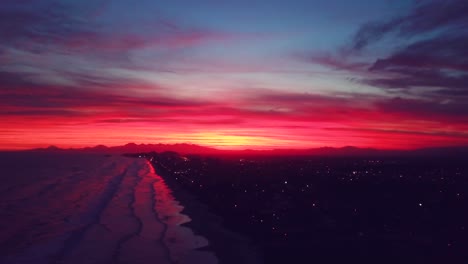 Stunning-parallax-aerial-shot-of-sunset-in-Brazil,-showing-beach-and-sun-in-unbelieveable-color