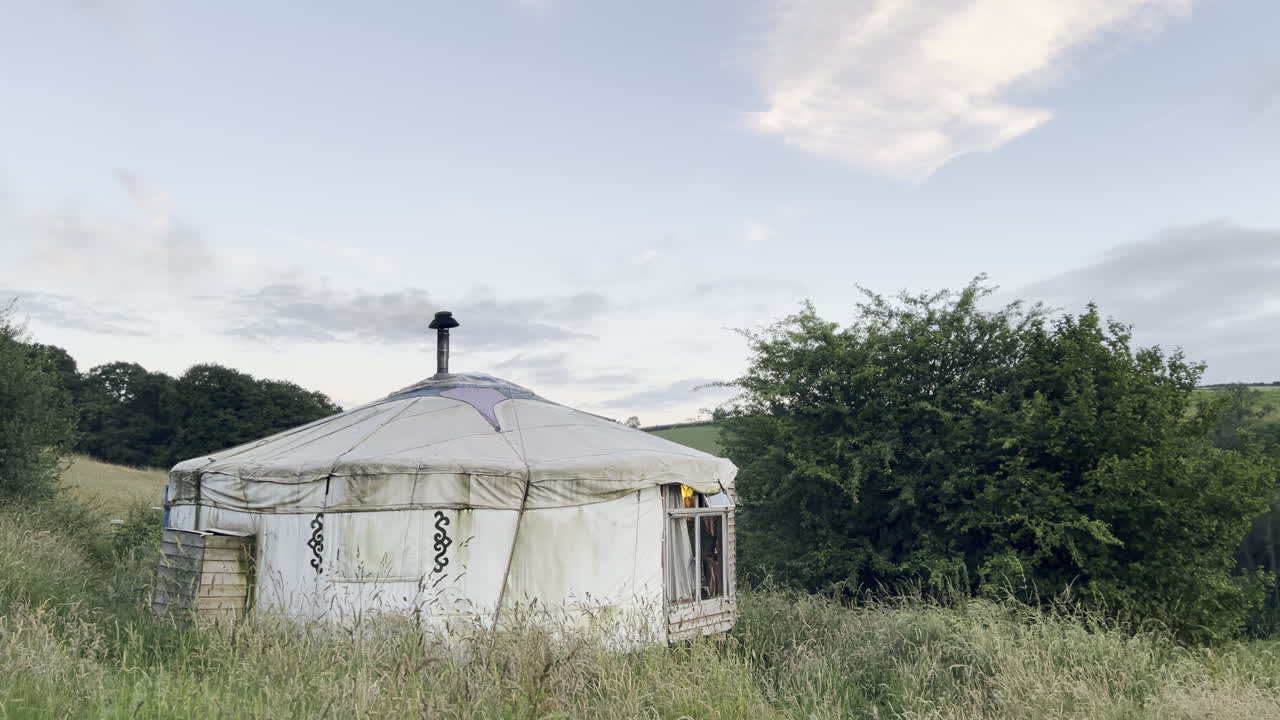 Yurt camping in the countryside of England rolling hills smoke from the chimney