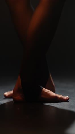 close-up of dancer's legs and feet in black tights