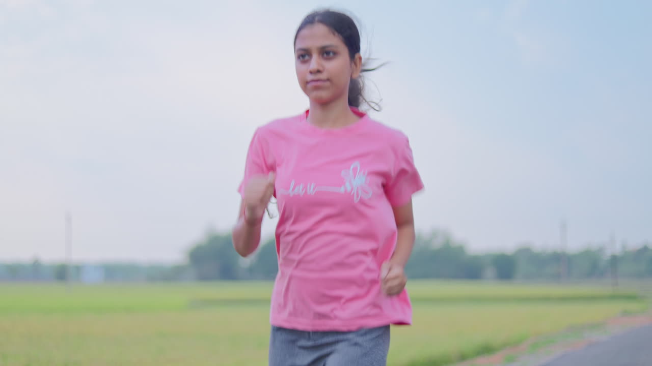 A female athlete running outdoors in early morning