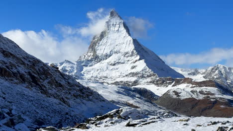 Lake-Riffelsee-Zermatt-Switzerland-Glacier-peak-Gornergrat-Railway-train-stop-October-blue-sky-The-Matterhorn-clear-peak-ski-resort-first-fresh-snowfall-landscape-scenery-autumn-Swiss-Alps-slide-shot