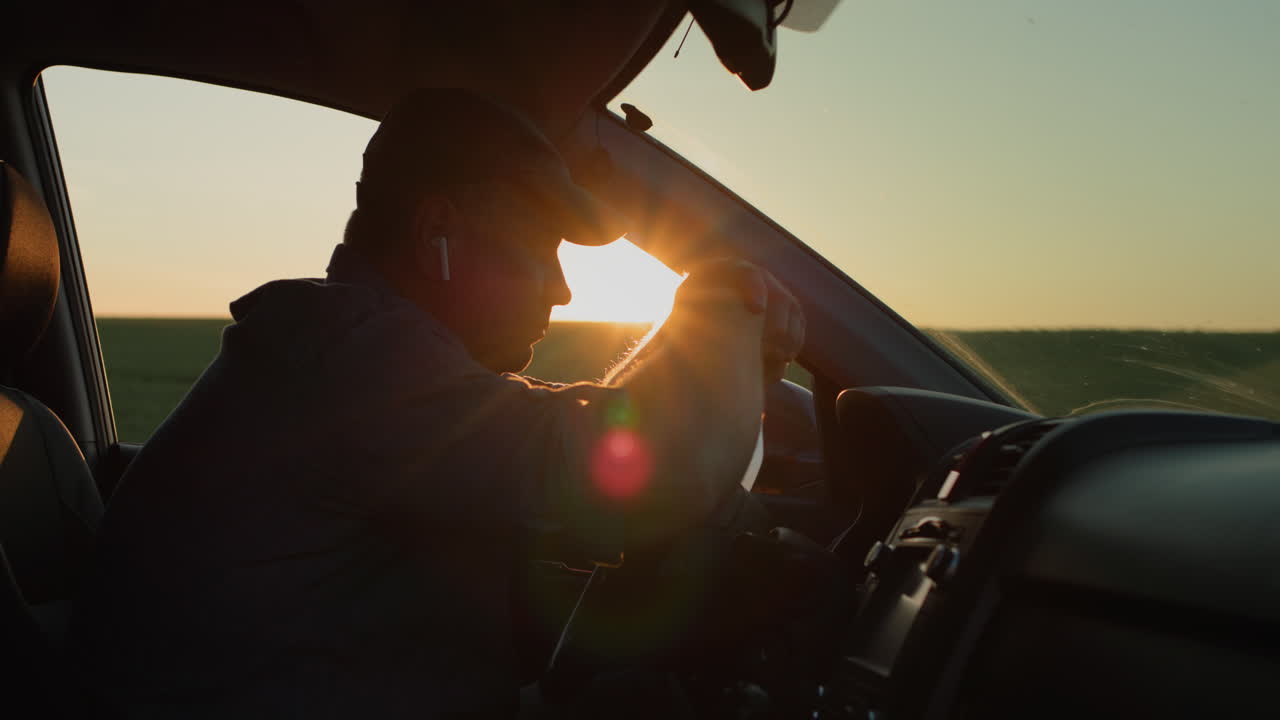 Alone sad man sitting behind the wheel of a car