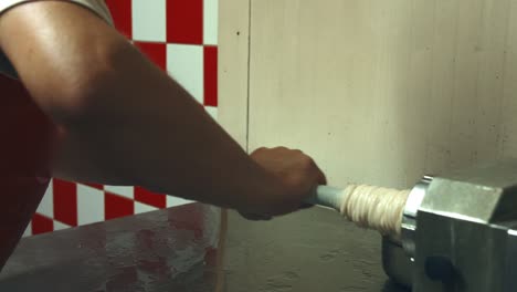 butcher hands dress pork intestines on a sausage attachment-1