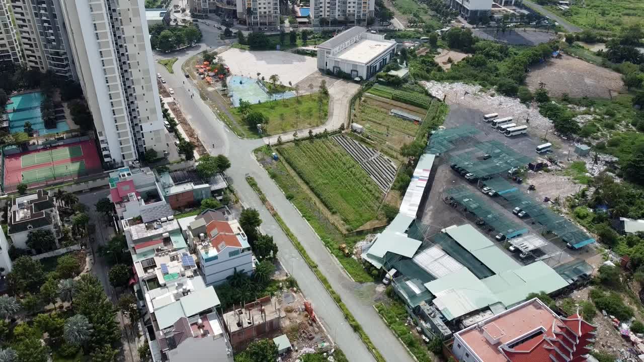 Drone bird's eye view above open courtyard and road scene in Ho Chi Minh City