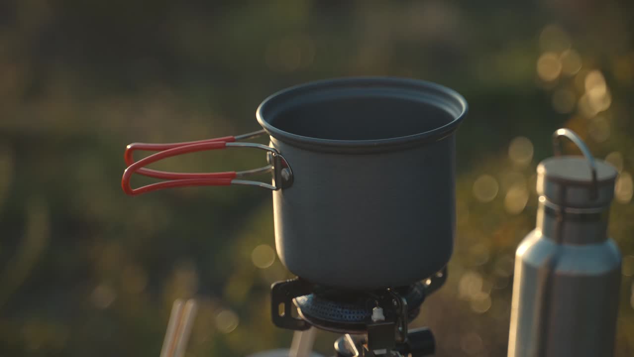 Cooking on a Camp Stove at Sunrise
