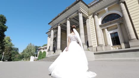 pretty bride near the old building. pretty bride walking near the old building in summer day