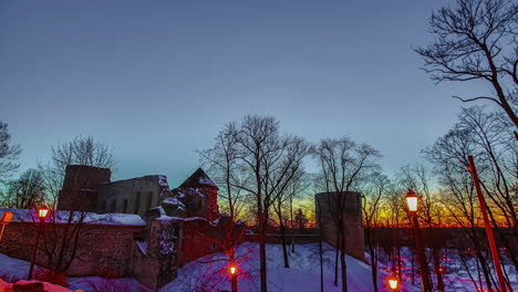 streetlamps brighten as the light changes from twilight to darkness at an historic castle in europe - time lapse