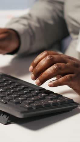 vertical video close up of data center admin coding on pc, typing on computer keyboard
