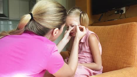 mother helping daughter with a personal care task