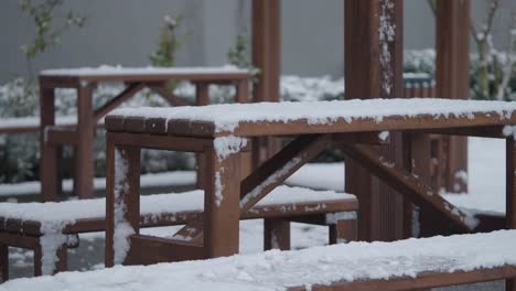 snowy outdoor wooden tables and benches