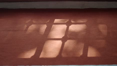 window shadow on a brown surface