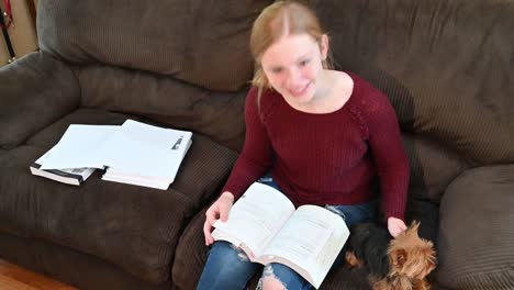 A-small-Yorkshire-Terrier-accompanies-Madelyne-while-studying-for-an-exam