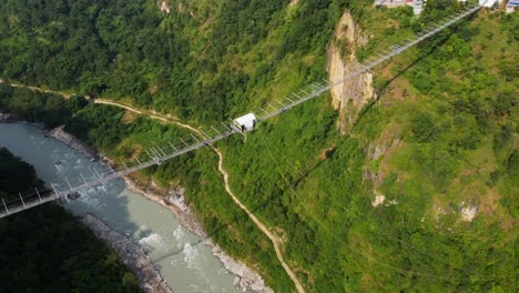 person bungee jumps off kushma suspension bridge in nepal