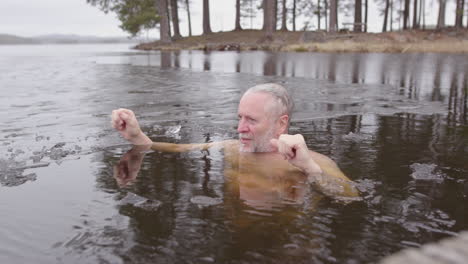 a man relaxes in the ice cold lakewater, reaping the health benefits