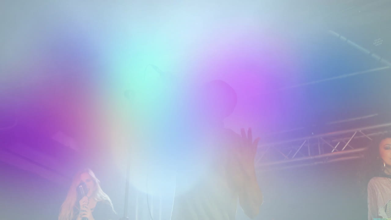 Three singers performing on concert stage, with animated microphone icons and glowing light beams