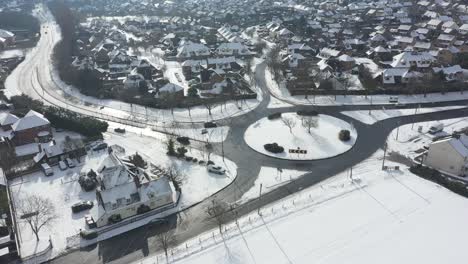 Aerial-shot-hover-above-snow-covered-roundabout
