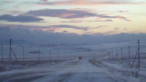 winter blizzard at sunset with track
